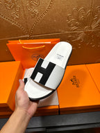 Hermes slide sandal held: white footbed with black H-style strap