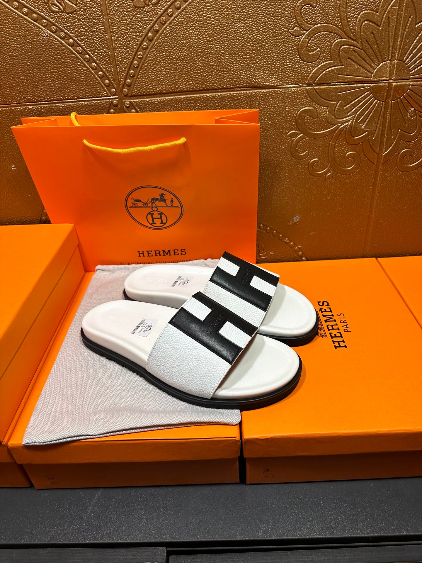 Hermes slide sandals, white textured strap with black H-shaped buckle detail