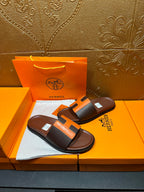 Leather sandals with orange H strap detail, dark footbed, pair on Hermes box