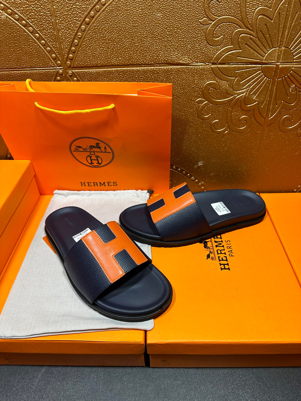 Hermes slide sandals, dark navy and orange H straps with a padded, flat sole