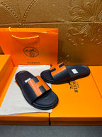 Hermes slide sandals, dark navy and orange H straps with a padded, flat sole