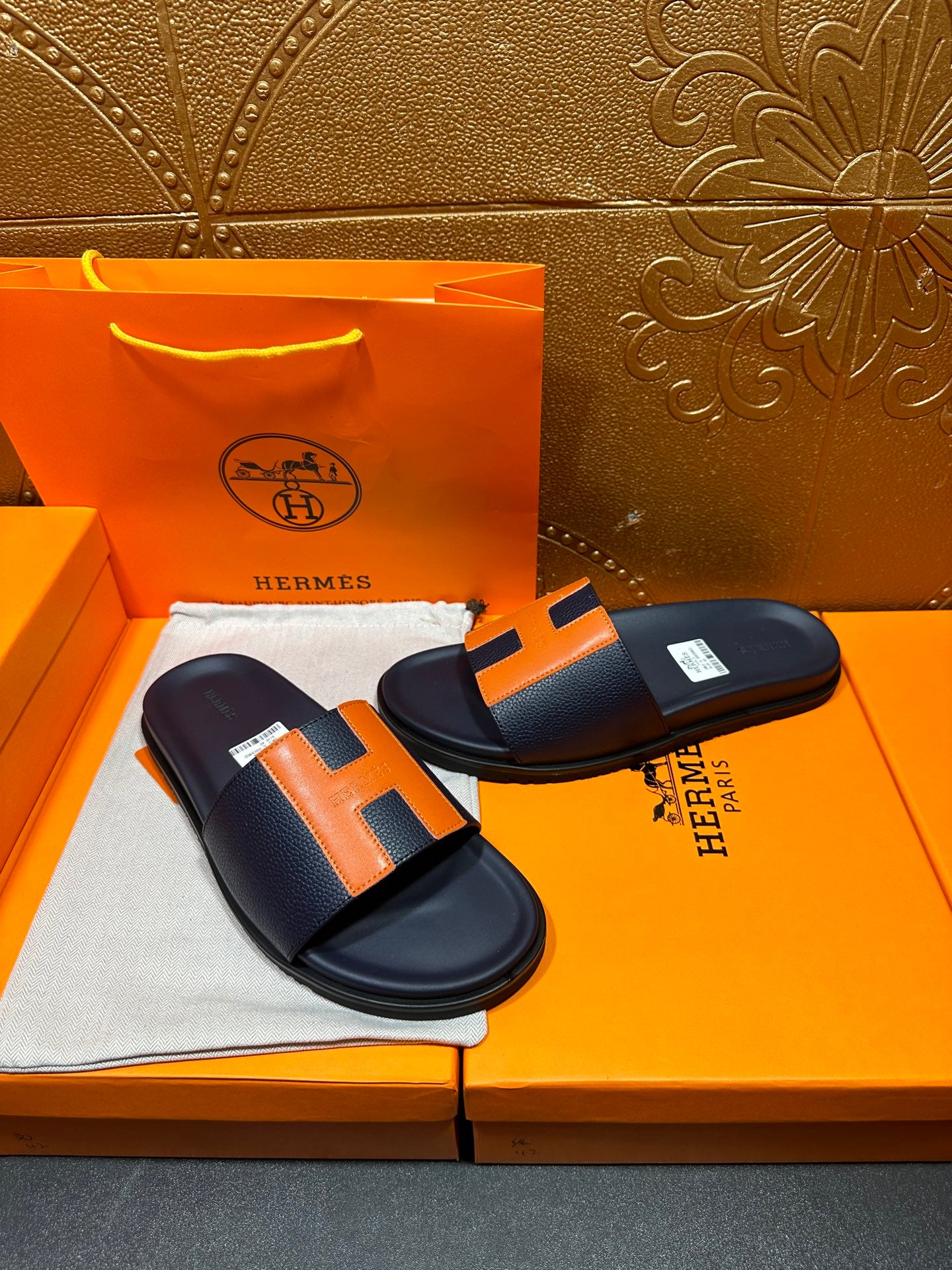 Hermes slide sandals, dark navy and orange H straps with a padded, flat sole