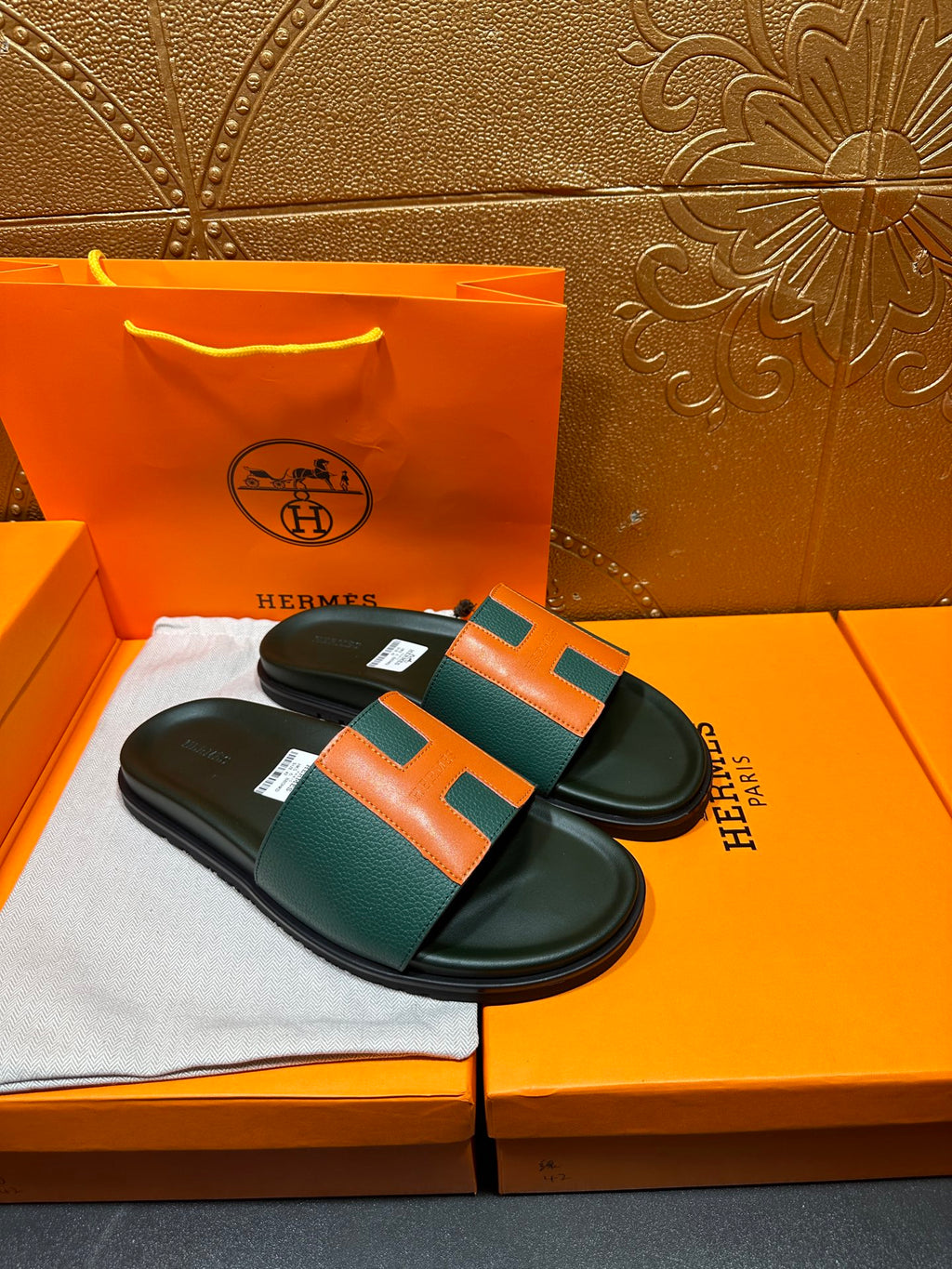 Hermes slide sandals, pair view: green straps with orange H details and black base