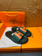 Hermes slide sandals, pair view: green straps with orange H details and black base