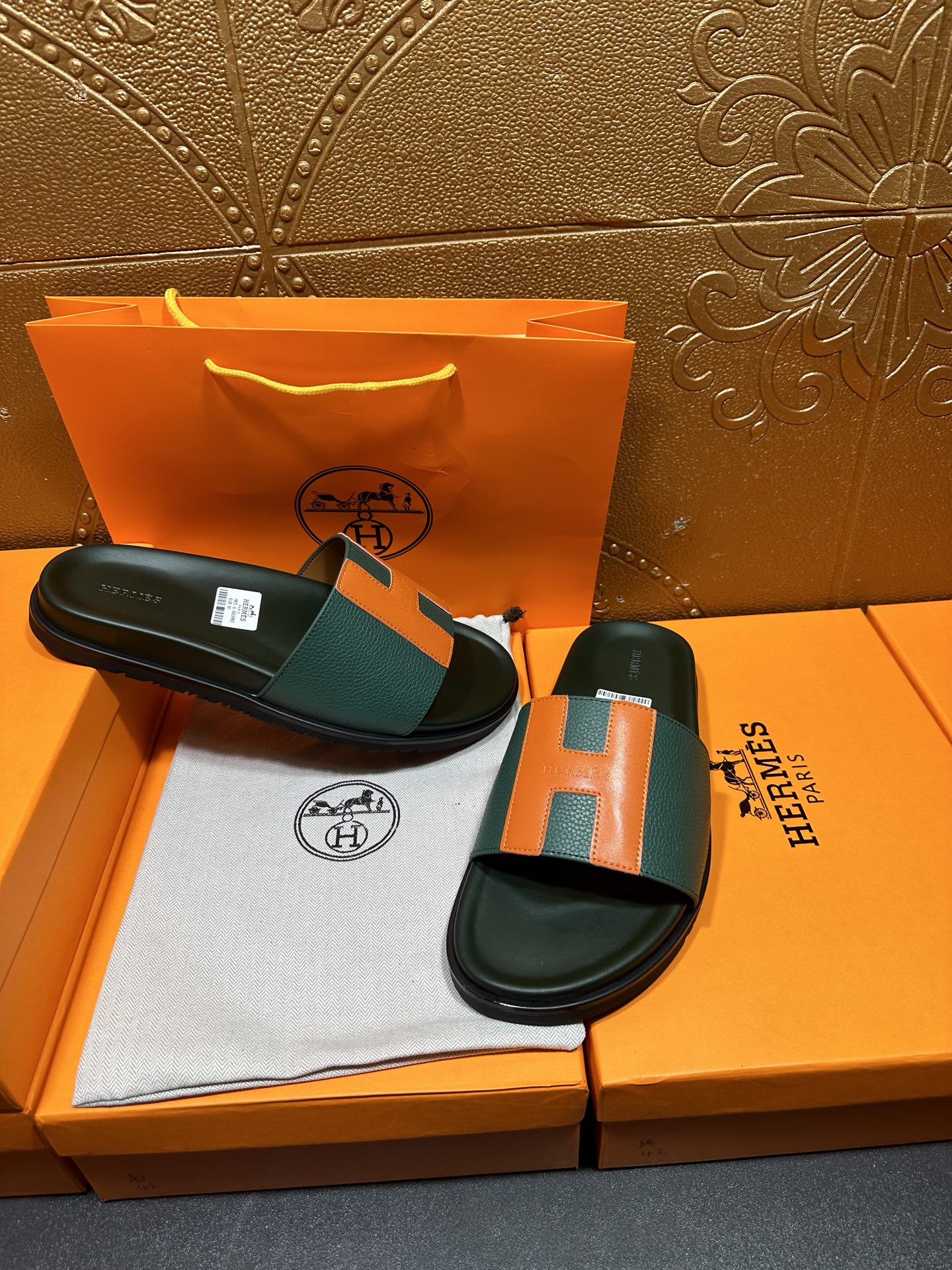 Hermes slide sandals with green and orange H straps, black sandals on shoebox