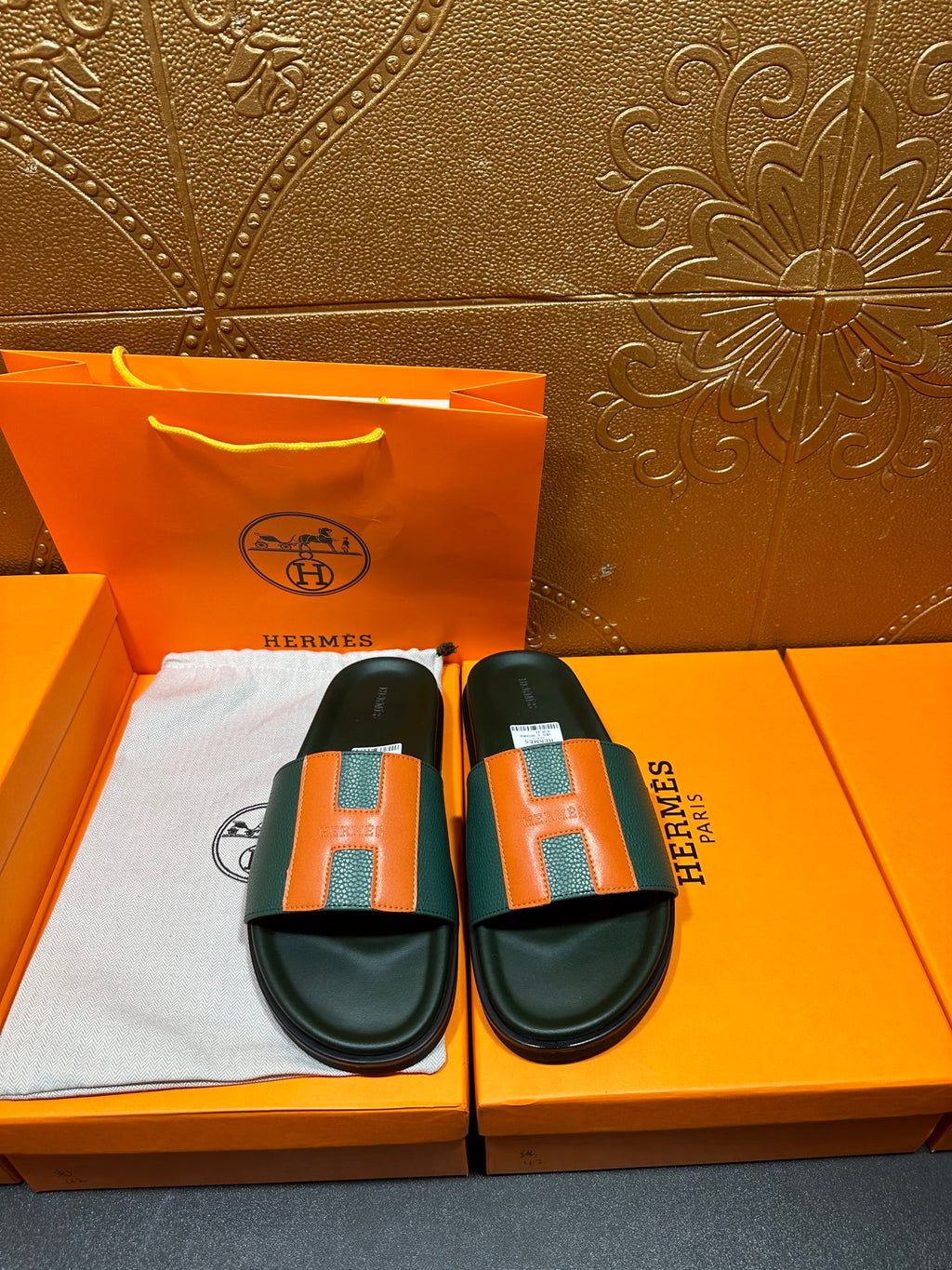 Hermes slide sandals, front pair: green straps with orange H squares, black soles