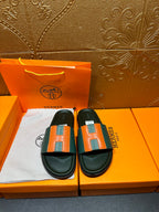 Hermes slide sandals, front pair: green straps with orange H squares, black soles
