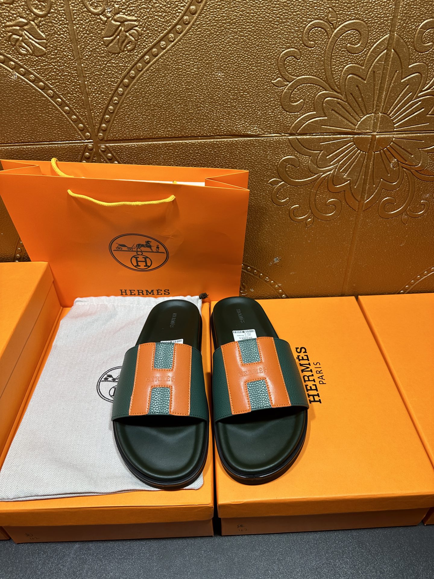 Hermes slide sandals, front pair: green straps with orange H squares, black soles