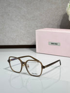 Brown tortoiseshell eyeglasses with gold-tone bridge detail and MiuMiu logo