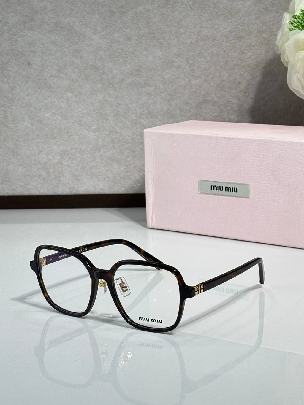 Black full-rim eyeglasses with clear lenses and MiuMiu logo, centered front view