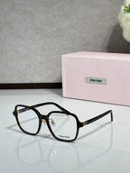 Black full-rim eyeglasses with clear lenses and MiuMiu logo, centered front view