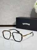 Black eyeglass frames with clear lenses and gold-tone metal temple accents.