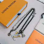 Louis Vuitton necklace display, silver-tone and dark-tone chains with LV charm