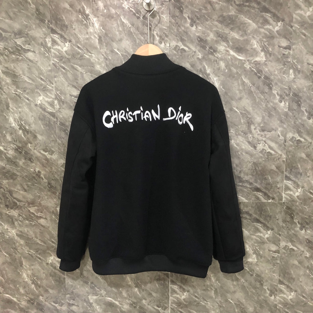 Dior long jacket back view with white Christian Dior logo on dark fabric