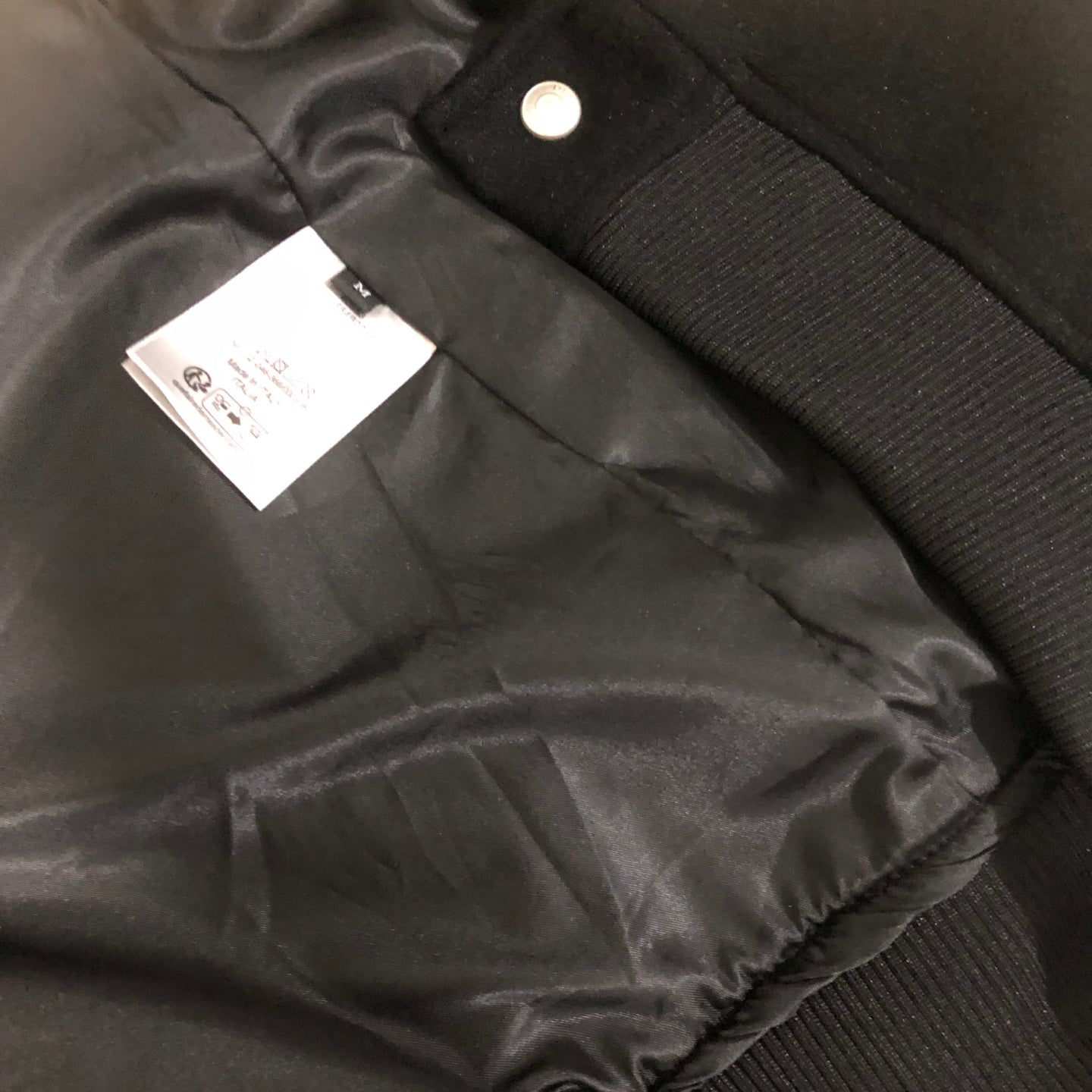 Dior long jacket interior with satin lining, snap button, and fabric label tag