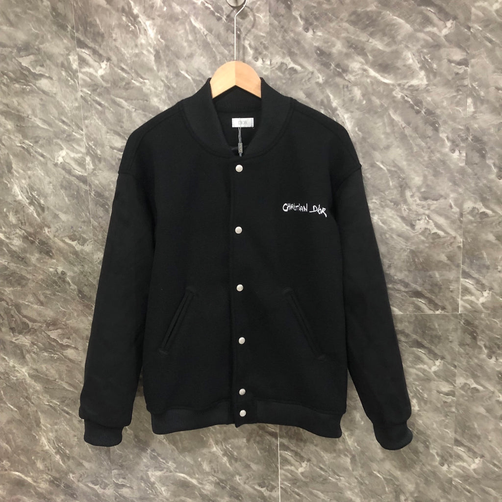 Dior long jacket in dark fabric with front snap buttons and ribbed cuffs and hem