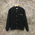 Dior long jacket in dark fabric with front snap buttons and ribbed cuffs and hem
