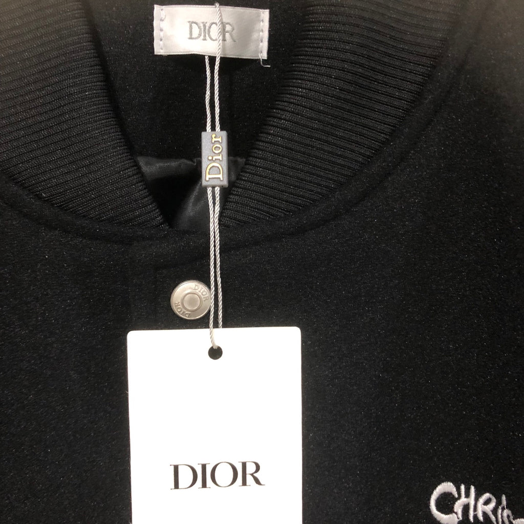 Dior long jacket collar close-up with snap placket and brand logo label