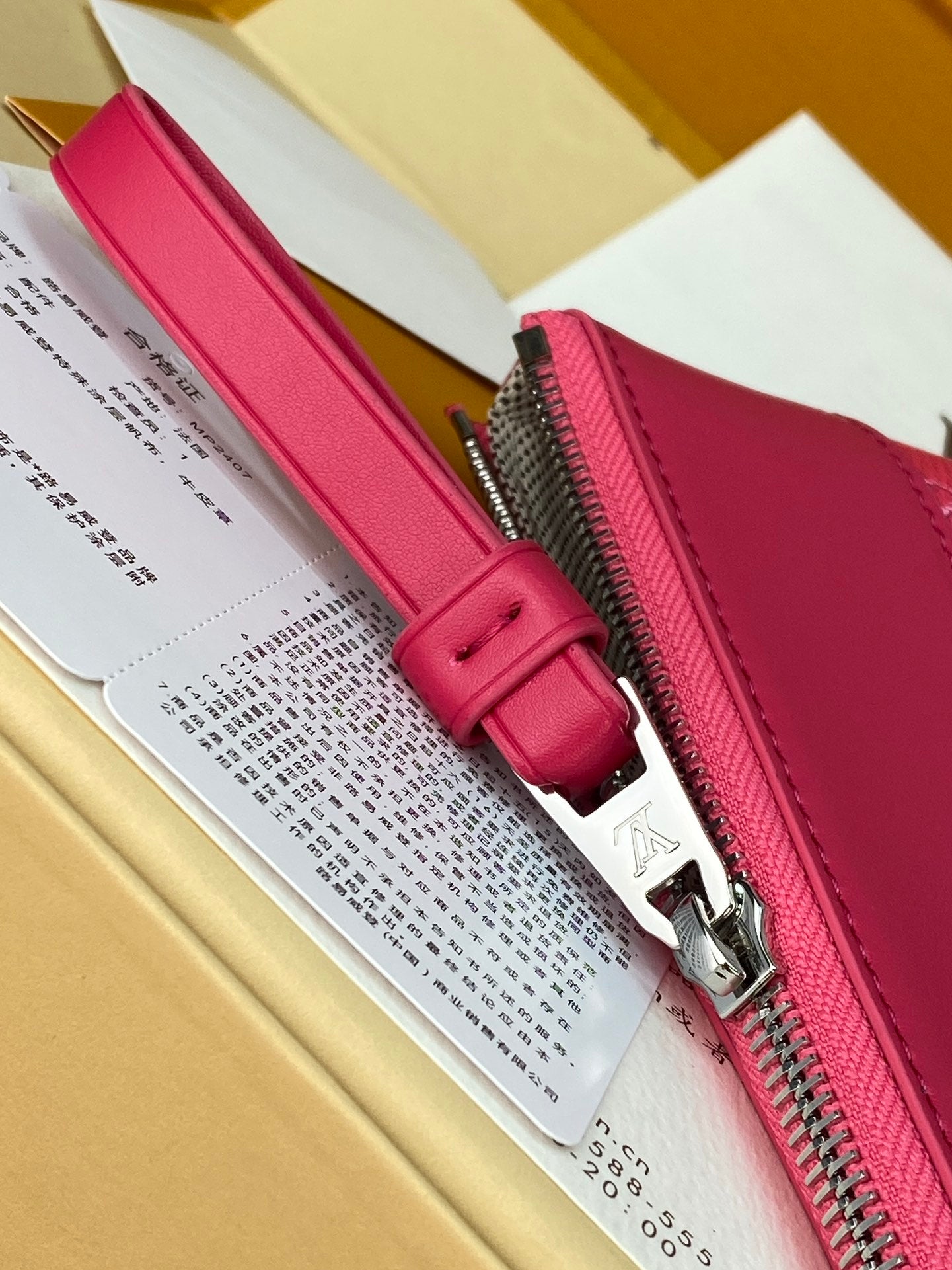 Louis Vuitton pink wristlet-style bag with zip closure and metal zipper