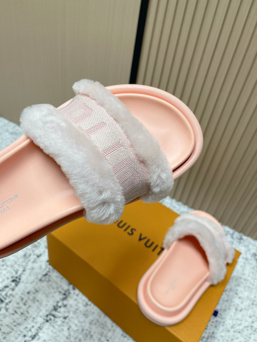 Louis Vuitton pink slide sandals angled view with fuzzy crossover strap