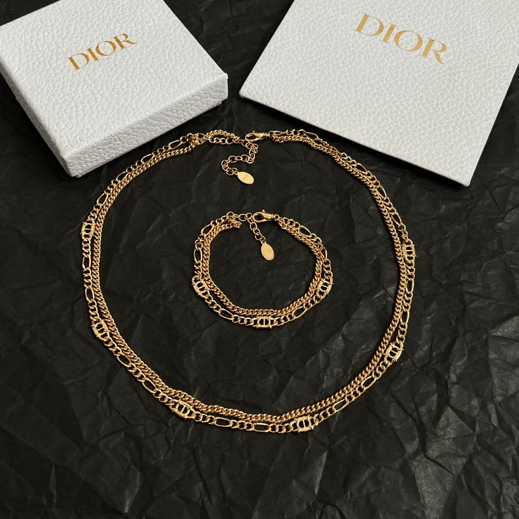 Gold-tone chain necklace with round charm and small pendant