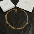 Gold-tone chain necklace with small round charm pendant
