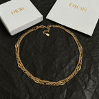 Gold-tone chain necklace with small round charm pendant