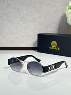 Round sunglasses with black frames, gold accents, and dark tinted lenses.