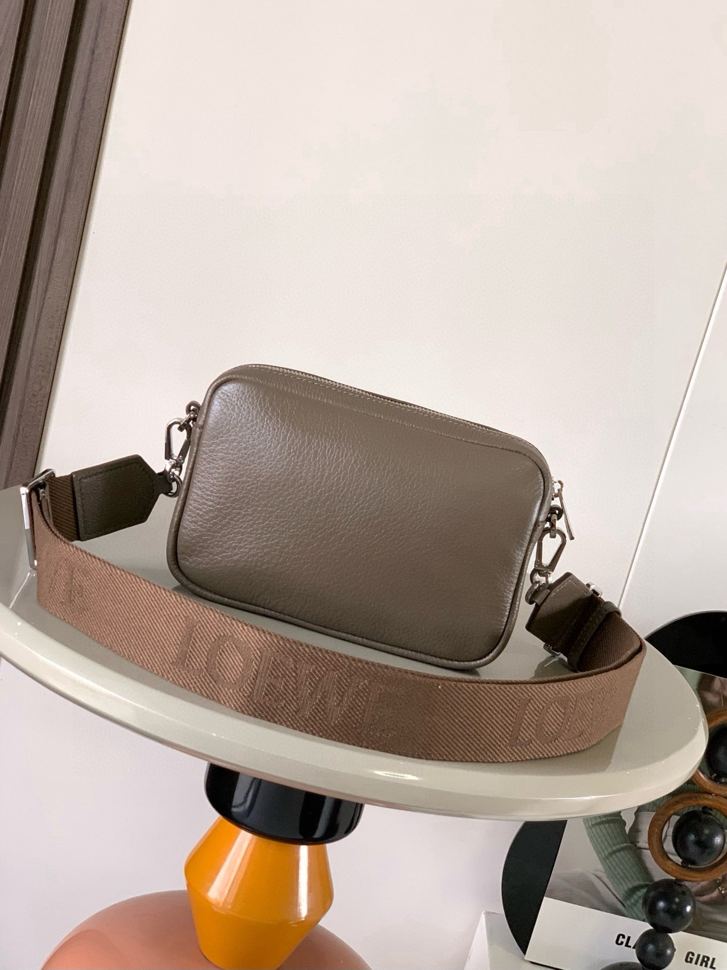 Loewe men's taupe leather crossbody bag with patterned strap and front flap