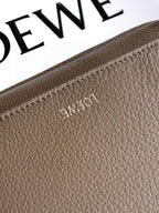 Loewe taupe leather bag detail with embossed logo on textured grain