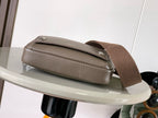 Taupe leather crossbody bag with top flap, silver-tone studs, and adjustable strap