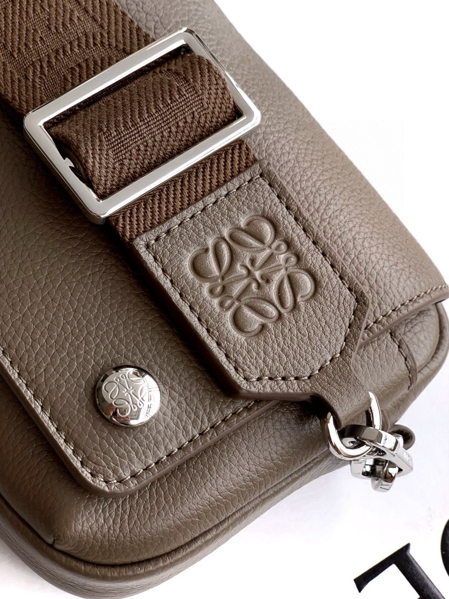 Loewe taupe leather crossbody strap buckle and embossed logo hardware detail