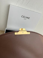 Celine brown leather bag handle mount with gold-tone bar and metal studs