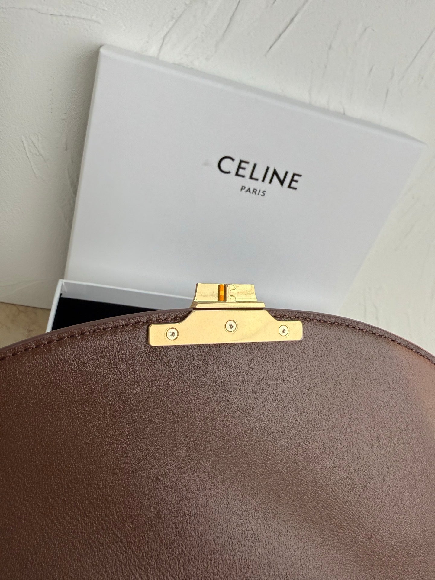 Celine brown leather bag handle mount with gold-tone bar and metal studs