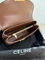 Celine brown leather bag open to show interior lining and gold zipper pocket