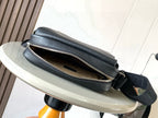 Men's dark leather crossbody bag with open zip compartment and strap