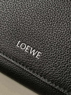 Black leather brand patch with embossed LOEWE lettering