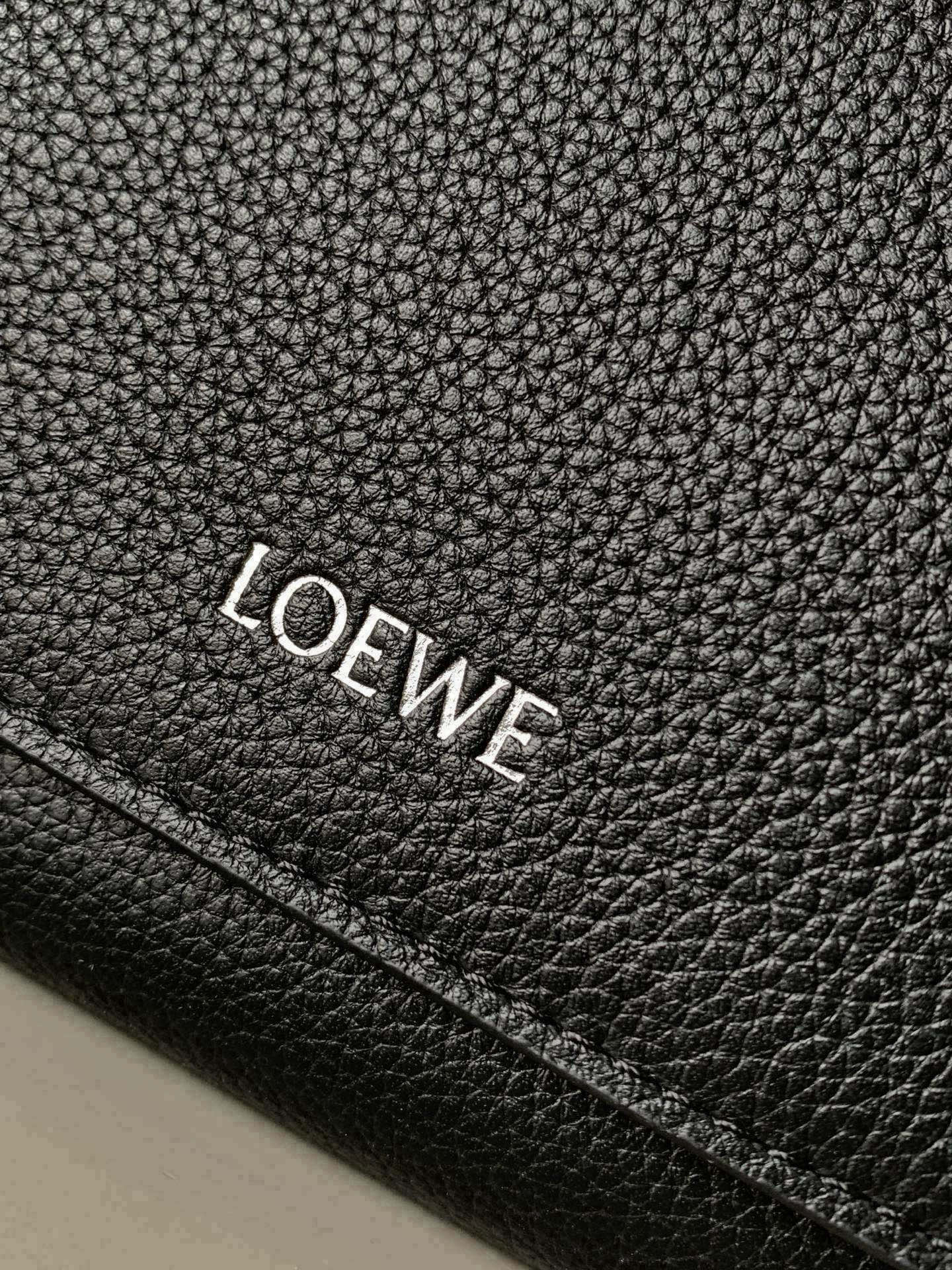 Black leather brand patch with embossed LOEWE lettering