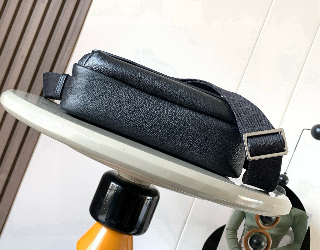 Pebbled leather crossbody bag with wide front flap and adjustable strap