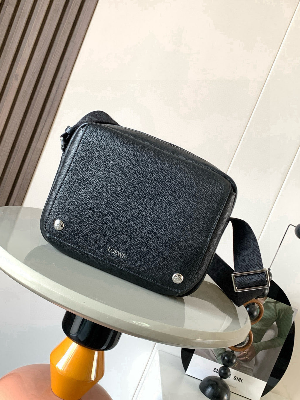 Men's dark leather crossbody bag with flap and silver snap buttons