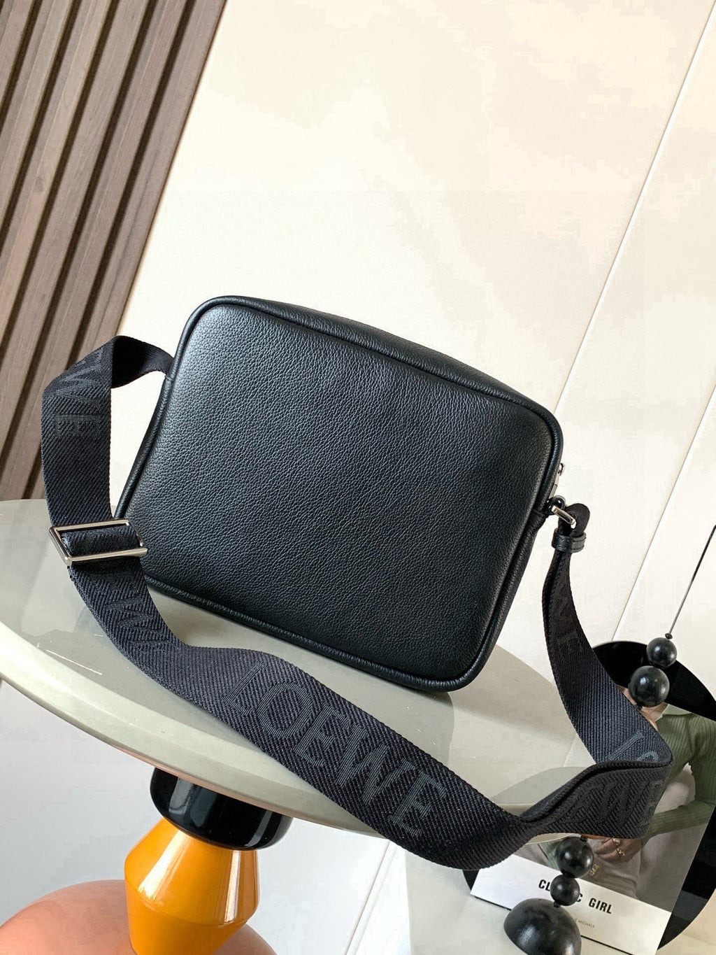 Men's dark leather crossbody bag with front flap and jacquard shoulder strap