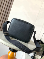 Men's dark leather crossbody bag with front flap and jacquard shoulder strap