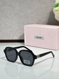 MiuMiu black square eyeglasses with dark lenses and gold logo temple tips