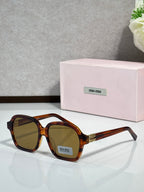 MiuMiu amber tortoiseshell square eyeglasses with brown lenses and gold logo temples