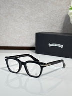 Black full-rim eyeglasses with gold detailing on the temples and rectangular lenses