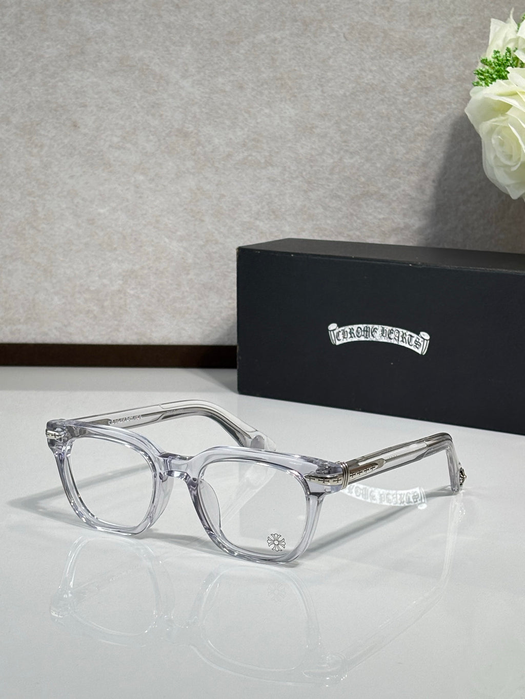 Clear full-rim eyeglasses with gold-accent temples and rectangular lenses