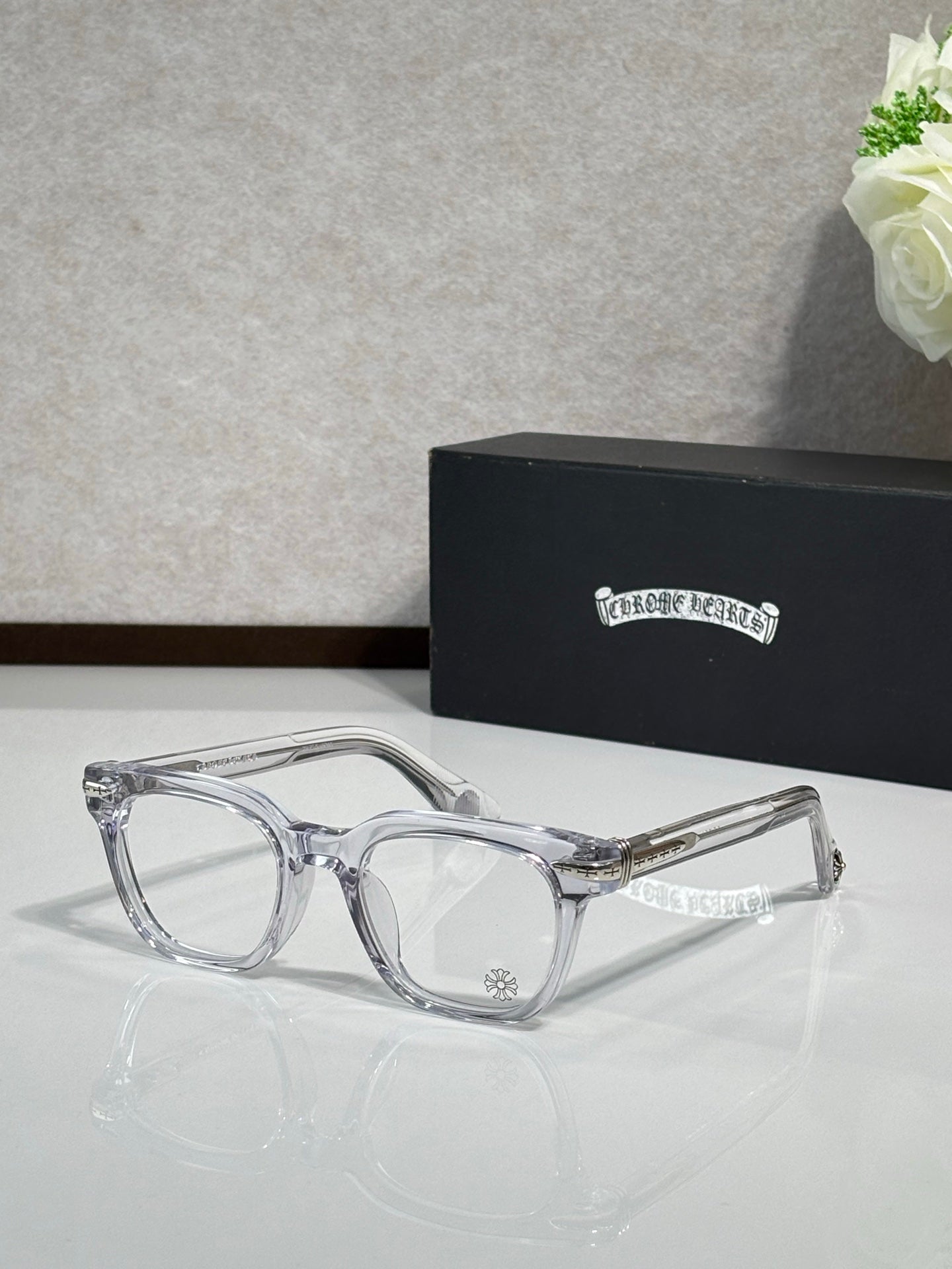 Clear full-rim eyeglasses with gold-accent temples and rectangular lenses