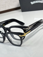 Black full-rim eyeglasses with gold temple detailing and rectangular lenses