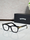 Black full-rim eyeglasses with gold-accent temples and rectangular lenses