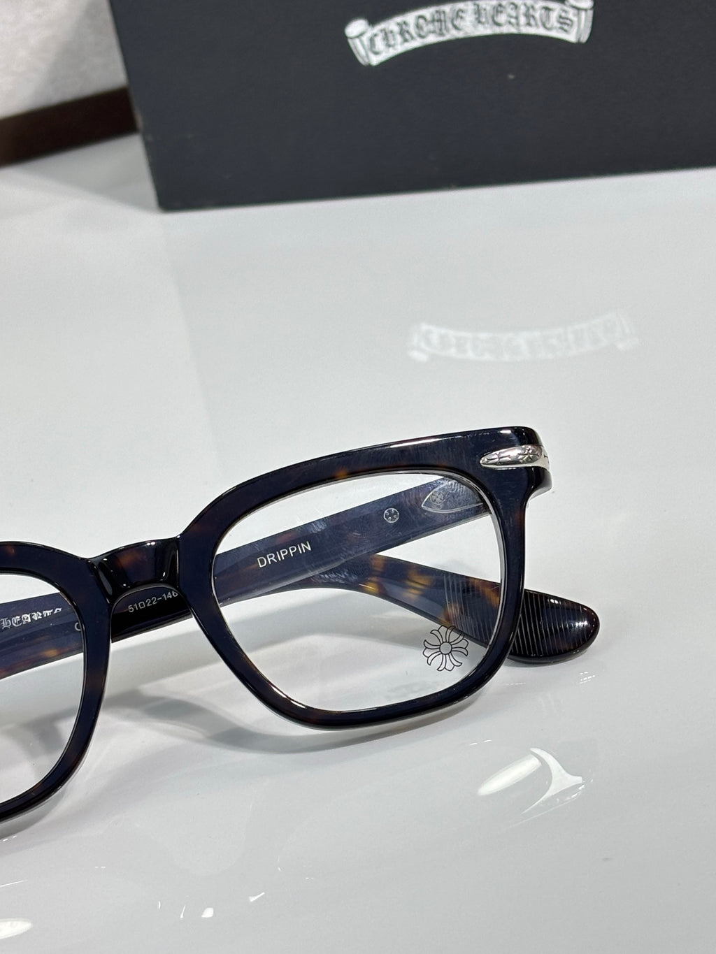 Navy full-rim eyeglasses with logo detail on the temple and round-rectangular lenses